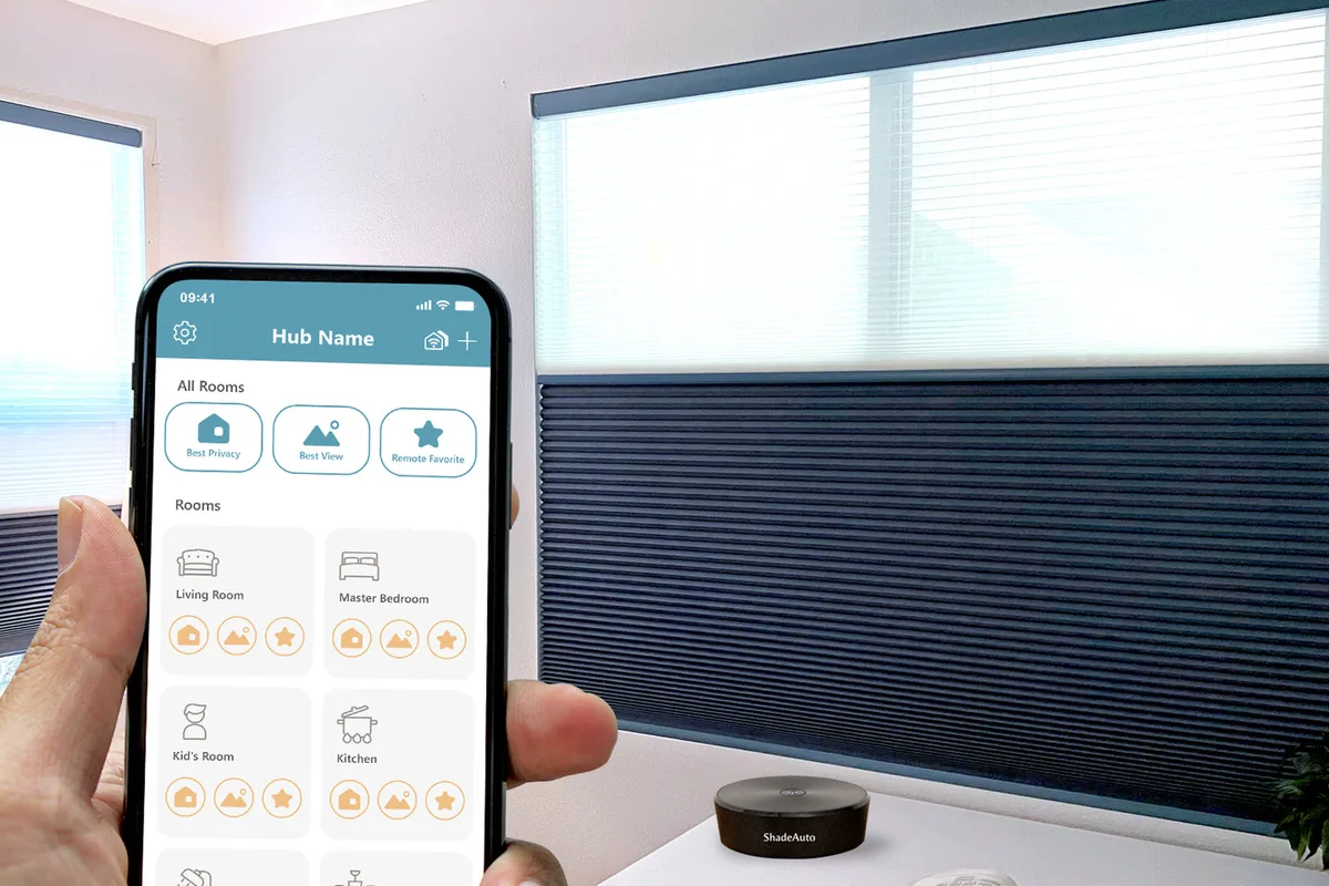 The ShadeAuto app on a phone with shades grouped by room, next to the hub on a side table